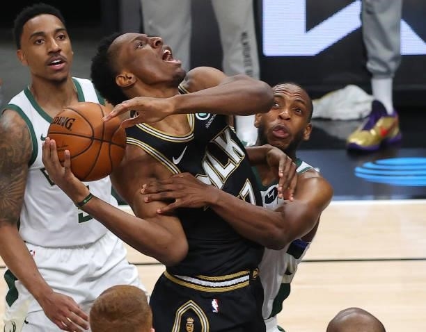 Khris Middleton of the Milwaukee Bucks fouls Onyeka Okongwu of the Atlanta Hawks during the first half in Game Six of the Eastern Conference Finals...