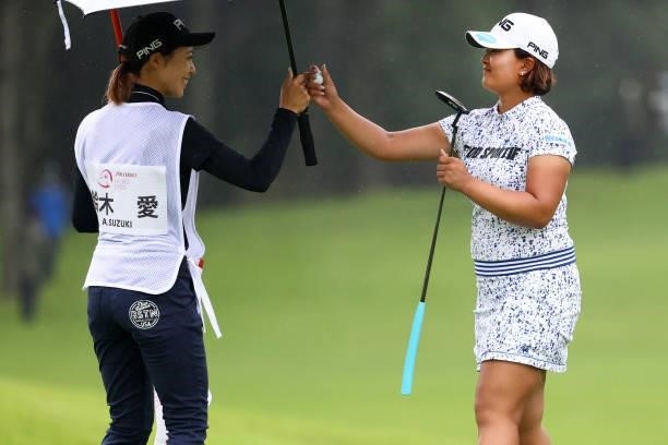 Ai Suzuki of Japan high fives with her caddie after the birdie on the 9th green during the final round of the Shiseido Ladies Open at Totsuka Country...