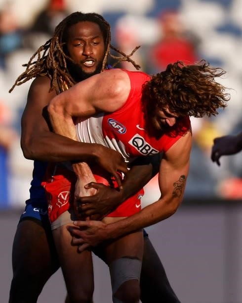Tom Hickey of the Swans is tackled by Nic Naitanui of the Eagles during the round 16 AFL match between Sydney Swans and West Coast Eagles at GMHBA...