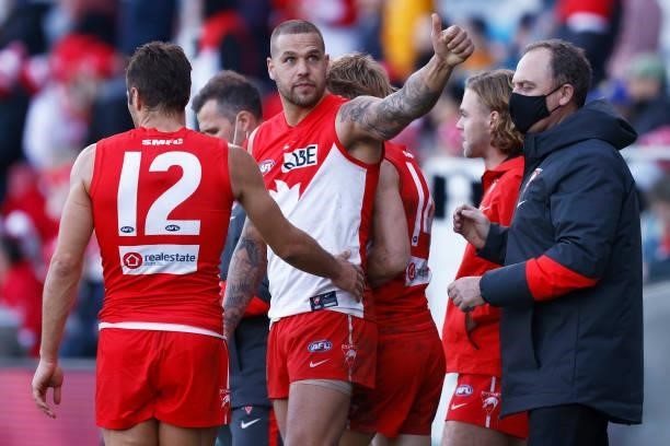 Lance Franklin of the Swans gestures to a friend in the crowd as Josh P. Kennedy of the Swans and Swans head coach John Longmire celebrate victory...