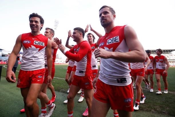The Swans celebrate as they leave the field after winning the round 16 AFL match between Sydney Swans and West Coast Eagles at GMHBA Stadium on July...
