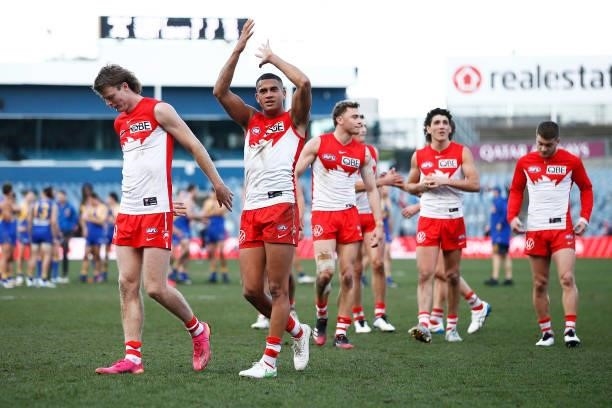 James Bell of the Swans and teammates thank fans after the round 16 AFL match between Sydney Swans and West Coast Eagles at GMHBA Stadium on July 04,...