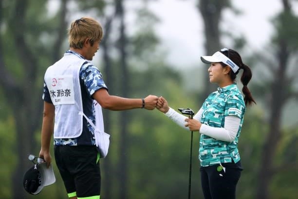Serena Aoki of Japan fist bumps with her caddie after holing out on the 18th green during the final round of the Shiseido Ladies Open at Totsuka...