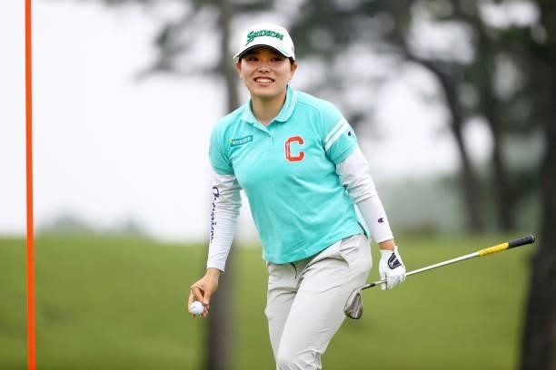 Minami Katsu of Japan picks up her ball after making a chip-in-birdie on the 18th green during the final round of the Shiseido Ladies Open at Totsuka...