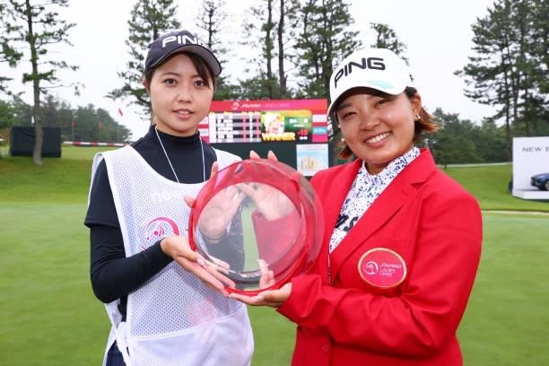 Ai Suzuki of Japan poses with her caddie after winning the tournament following the final round of the Shiseido Ladies Open at Totsuka Country Club...