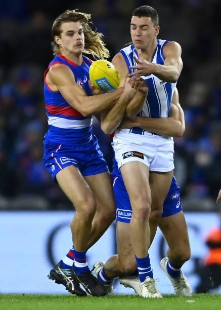 Luke Davies-Uniacke of the Kangaroos is tackled by Bailey Smith of the Bulldogs during the round 16 AFL match between Western Bulldogs and North...