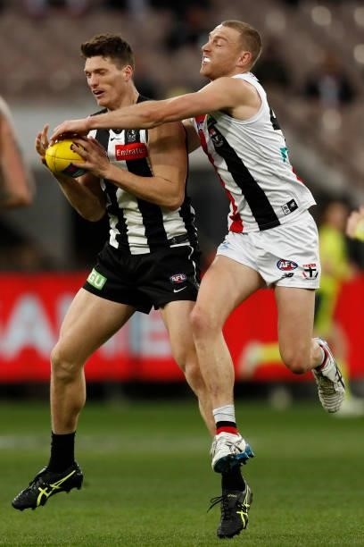 Brody Mihocek of the Magpies marks the ball in front of Callum Wilkie of the Saints during the round 16 AFL match between Collingwood Magpies and St...