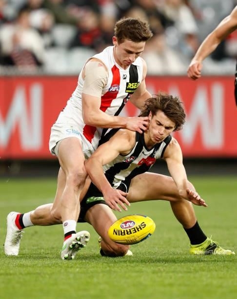Jack Billings of the Saints applies pressure to Caleb Poulter of the Magpies during the round 16 AFL match between Collingwood Magpies and St Kilda...
