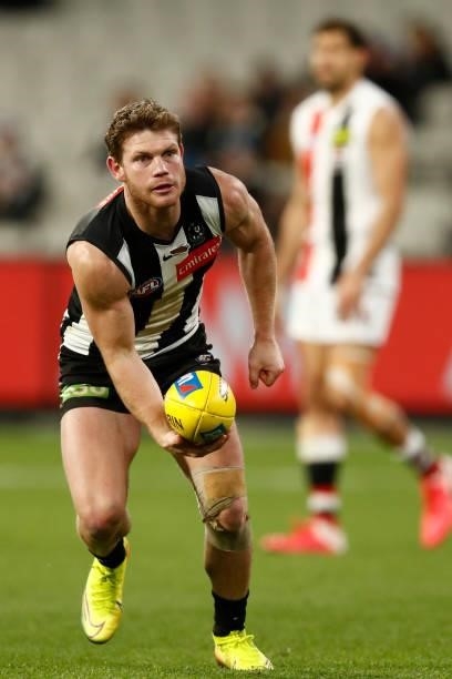 Taylor Adams of the Magpies handballs during the round 16 AFL match between Collingwood Magpies and St Kilda Saints at Melbourne Cricket Ground on...