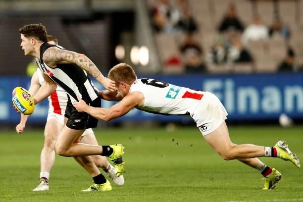 Sebastian Ross of the Saints tackles Jack Crisp of the Magpies during the round 16 AFL match between Collingwood Magpies and St Kilda Saints at...