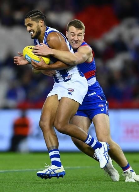 Aaron Hall of the Kangaroos is tackled by Jackson Macrae of the Bulldogs during the round 16 AFL match between Western Bulldogs and North Melbourne...