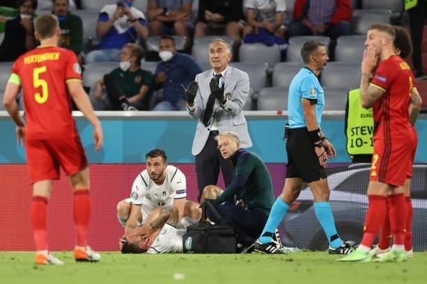 Leonardo Spinazzola of Italy receives treatment during the UEFA Euro 2020 Championship Quarter-final match between Belgium and Italy at Football...