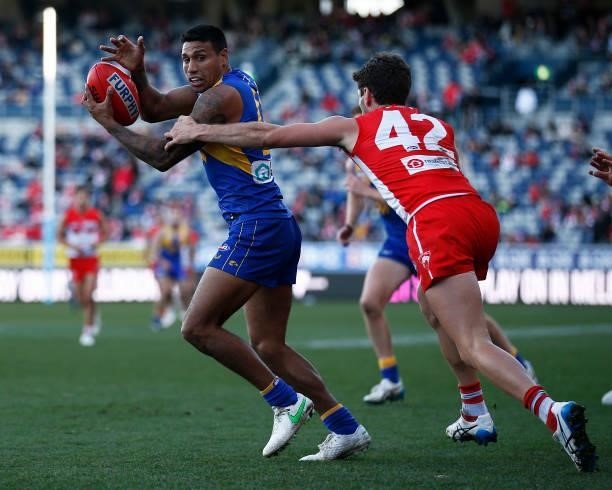 Tim Kelly of the Eagles runs away from Robbie Fox of the Swans during the round 16 AFL match between Sydney Swans and West Coast Eagles at GMHBA...