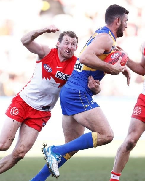 Jack Darling of the Eagles is tackled by Harry Cunningham of the Swans during the round 16 AFL match between Sydney Swans and West Coast Eagles at...