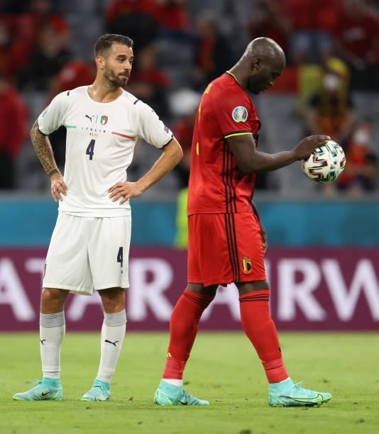 Leonardo Spinazzola of Italy talks to Romelu Lukaku of Belgium before a penalty during the UEFA Euro 2020 Championship Quarter-final match between...