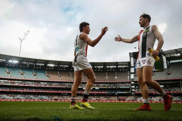 Rowan Marshall and Daniel McKenzie of the Saints high five while resting on the bench during the round 16 AFL match between Collingwood Magpies and...