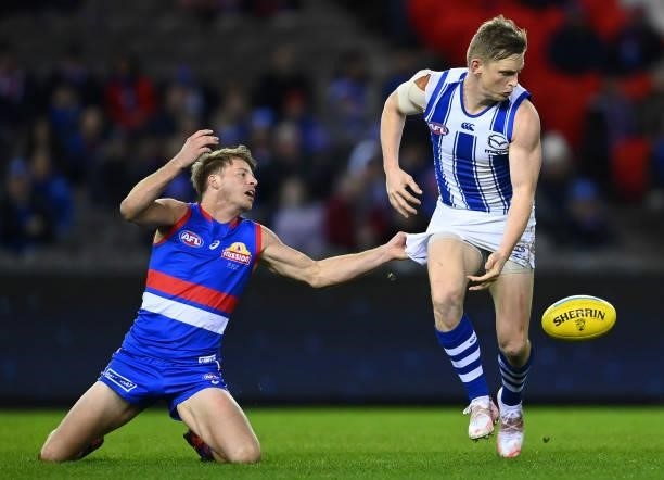 Jack Ziebell of the Kangaroos is tackled by Mitch Hannan of the Bulldogs during the round 16 AFL match between Western Bulldogs and North Melbourne...