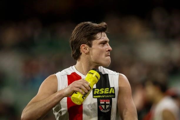 Jack Steele of the Saints looks into the crowd as a Collingwood fan yells abuse during the round 16 AFL match between Collingwood Magpies and St...