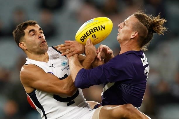 Jack Martin of the Blues and Nat Fyfe of the Dockers contest the ball during the round 16 AFL match between Fremantle Dockers and Carlton Blues at...