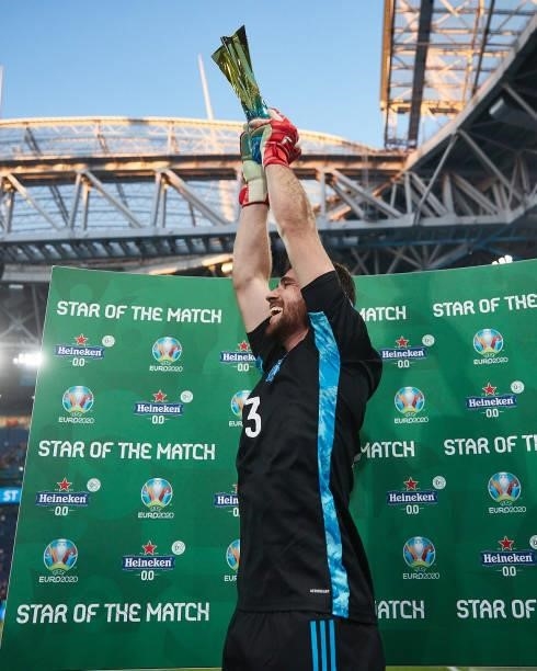 Goalkeeper Unai Simon of Spain jumps with Heineken Star of the match trophy after the UEFA Euro 2020 Championship Quarter-final match between...