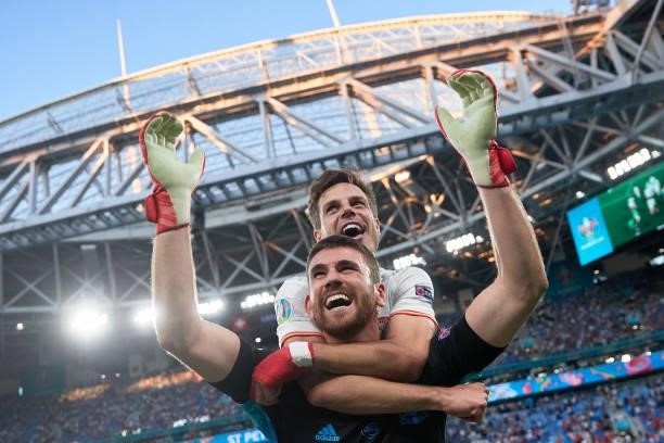 Goalkeeper Unai Simon of Spain celebrates with teammate Cesar Azpilicueta after winning the penalty shots of the UEFA Euro 2020 Championship...