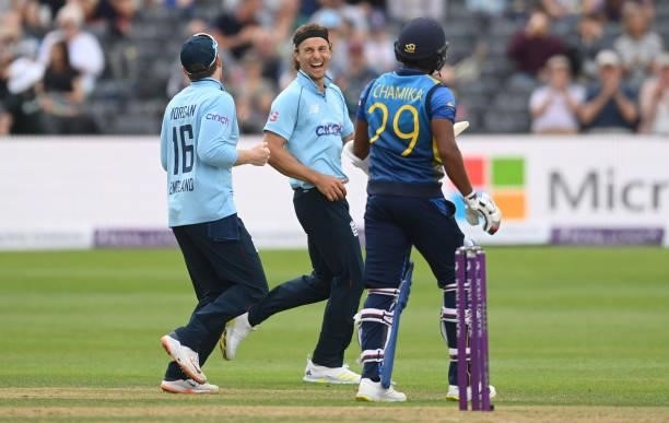 Tom Curran of England celebrates with Eoin Morgan after dismissing Chamika Karunaratne of Sri Lanka during the third One Day International between...
