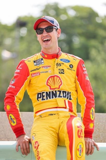 Joey Logano, driver of the Shell Pennzoil Ford, laughs on the grid during qualifying for the NASCAR Cup Series Jockey Made in America 250 Presented...