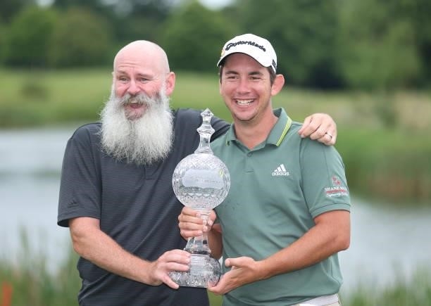Lucas Herbert of Australia holds the winners trophy with his caddie after the final round of The Dubai Duty Free Irish Open at Mount Juliet Golf Club...