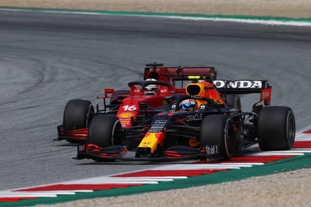Sergio Perez of Mexico driving the Red Bull Racing RB16B Honda leads Charles Leclerc of Monaco driving the Scuderia Ferrari SF21 during the F1 Grand...