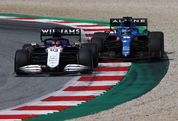 George Russell of Great Britain driving the Williams Racing FW43B Mercedes leads Fernando Alonso of Spain driving the Alpine A521 Renault during the...