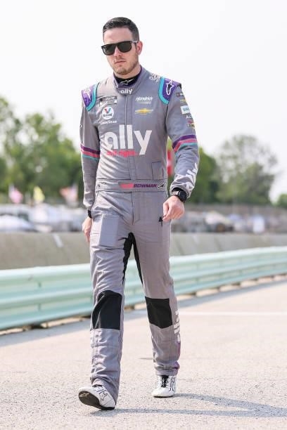 Alex Bowman, driver of the Ally Chevrolet, walks the grid during qualifying for the NASCAR Cup Series Jockey Made in America 250 Presented by Kwik...