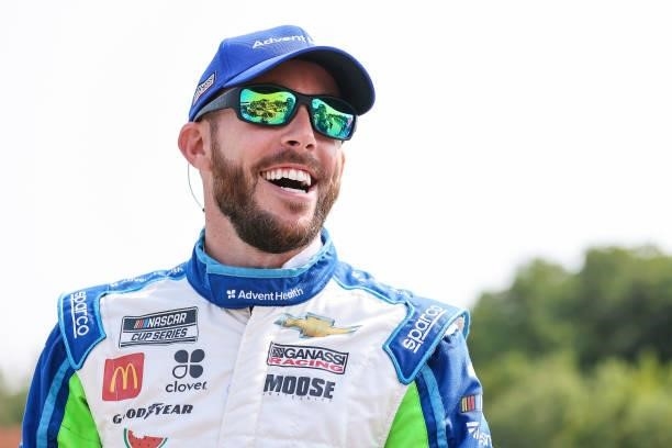 Ross Chastain, driver of the AdventHealth Chevrolet, laughs on the grid during qualifying for the NASCAR Cup Series Jockey Made in America 250...