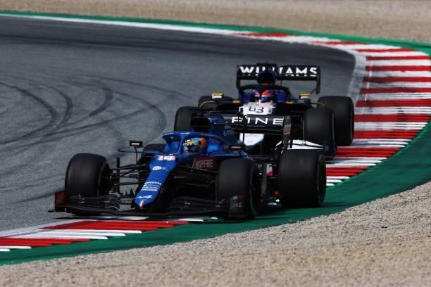 Fernando Alonso of Spain driving the Alpine A521 Renault leads George Russell of Great Britain driving the Williams Racing FW43B Mercedes during the...