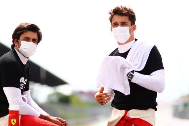 Carlos Sainz of Spain and Ferrari and Charles Leclerc of Monaco and Ferrari talk on the grid before the F1 Grand Prix of Austria at Red Bull Ring on...