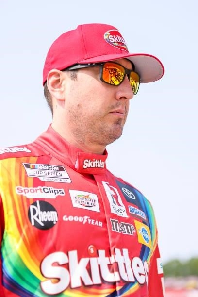 Kyle Busch, driver of the Skittles Red White & Blue Toyota, walks the grid during qualifying for the NASCAR Cup Series Jockey Made in America 250...
