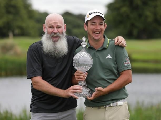 Lucas Herbert of Australia holds the winners trophy with his caddie after the final round of The Dubai Duty Free Irish Open at Mount Juliet Golf Club...