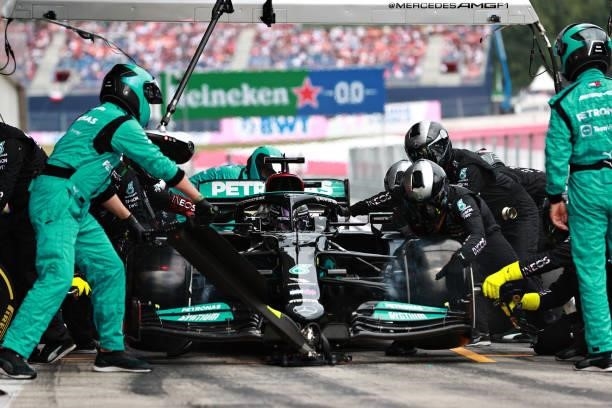 Lewis Hamilton of Great Britain driving the Mercedes AMG Petronas F1 Team Mercedes W12 makes a pitstop during the F1 Grand Prix of Austria at Red...