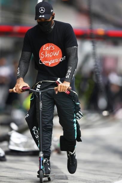 Lewis Hamilton of Great Britain and Mercedes GP rides a scooter to the grid before the F1 Grand Prix of Austria at Red Bull Ring on July 04, 2021 in...