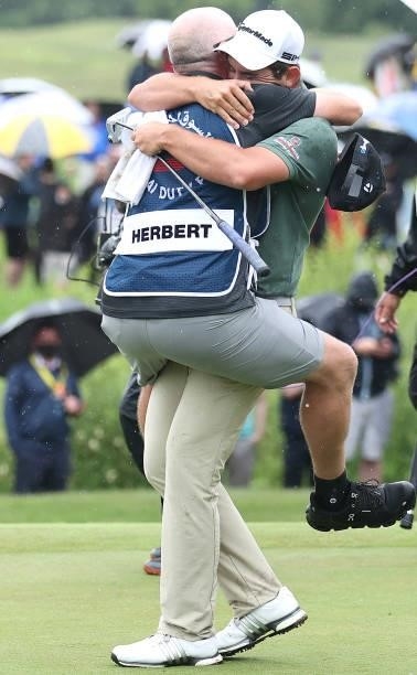 Lucas Herbert of Australia celebrates with caddie Nick Pugh after winning the Dubai Duty Free Irish Open at Mount Juliet Golf Club on July 04, 2021...
