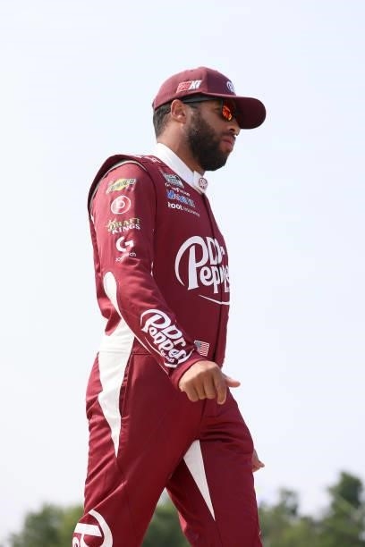 Bubba Wallace, driver of the Dr. Pepper Toyota, walks the grid during qualifying for the NASCAR Cup Series Jockey Made in America 250 Presented by...