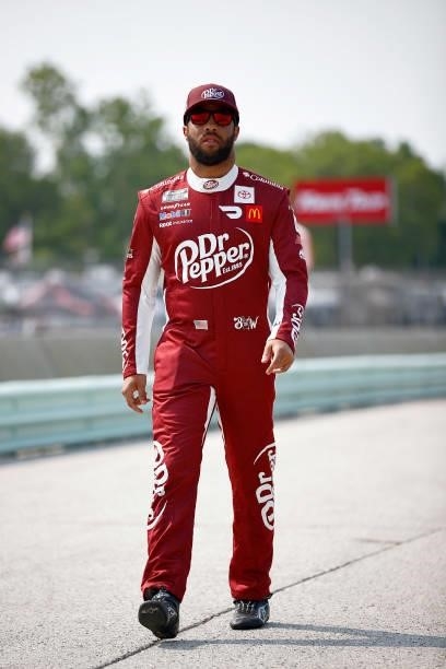 Bubba Wallace, driver of the Dr. Pepper Toyota, walks the grid during qualifying for the NASCAR Cup Series Jockey Made in America 250 Presented by...