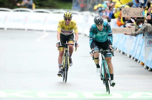 Race leader's yellow jersey Tadej Pogacar of Slovenia and UAE Team Emirates crosses the finish line behind Franck Bonnamour of France and BB Hotels -...