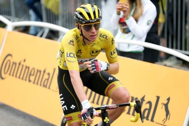 Race leader's yellow jersey Tadej Pogacar of Slovenia and UAE Team Emirates crosses the finish line of stage 9 of the 108th Tour de France 2021, a...