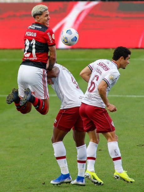 Pedro of Flamengo fight for the ball against Lucas Claro and Egidio of Fluminense during a match between Flamengo and Fluminense as part of...