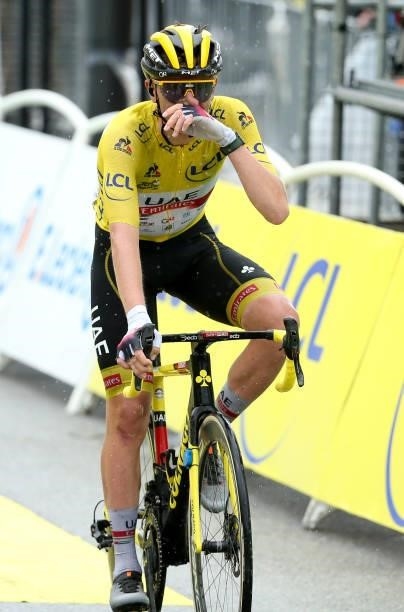 Race leader's yellow jersey Tadej Pogacar of Slovenia and UAE Team Emirates crosses the finish line of stage 9 of the 108th Tour de France 2021, a...