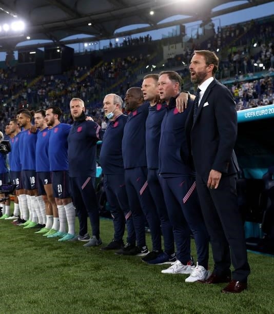 Gareth Southgate, Manager of England and coaching staff sing the national anthem prior to the UEFA Euro 2020 Championship Quarter-final match between...