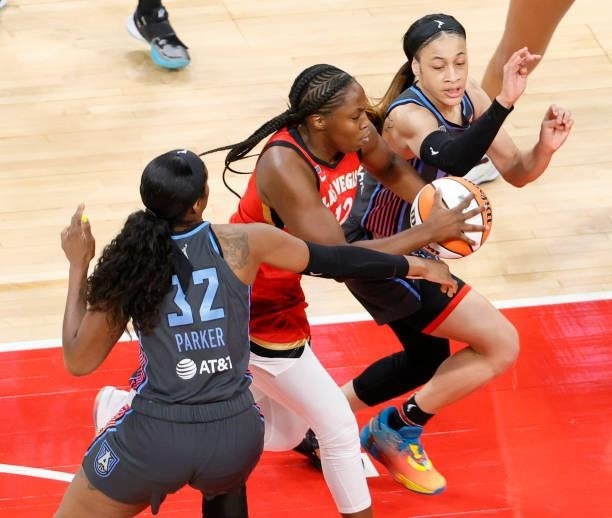 Chelsea Gray of the Las Vegas Aces drives between Cheyenne Parker and Chennedy Carter of the Atlanta Dream during their game at Michelob ULTRA Arena...