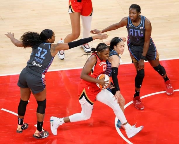 Chelsea Gray of the Las Vegas Aces is fouled by Chennedy Carter of the Atlanta Dream as Cheyenne Parker and Elizabeth Williams of the Dream defend...