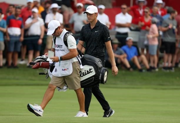 Cam Davis of Australia walks up the 18th hole in the first sudden death playoff hole with Troy Merritt during the final round of the Rocket Mortgage...