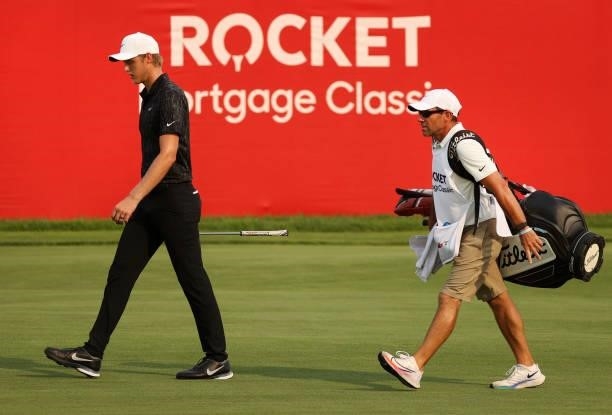 Cam Davis of Australia walks up the 18th hole in the first sudden death playoff hole with Troy Merritt during the final round of the Rocket Mortgage...